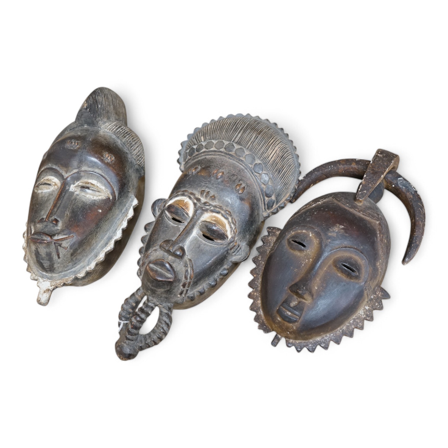 Three African carved hardwood masks, largest 39cm high. Condition - fair